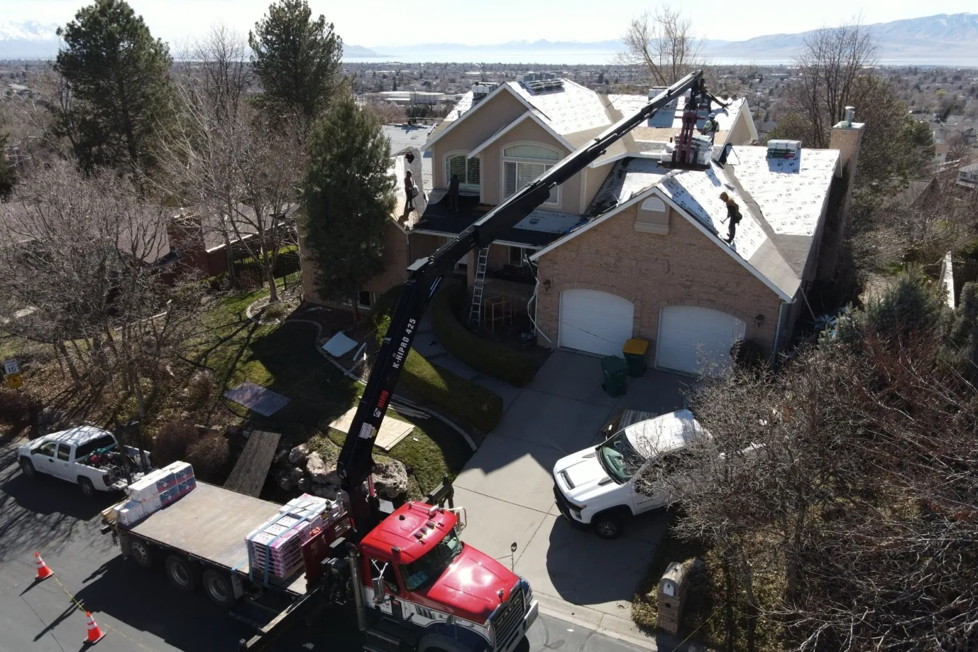 PowerHouse Roofing crew installing a roof on a Provo area home with Utah Valley views